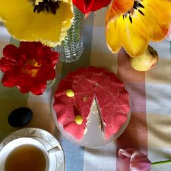 High angle view of red roses in vase on table