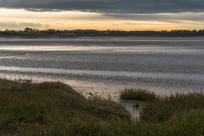 Scenic view of beach against sky during sunset
