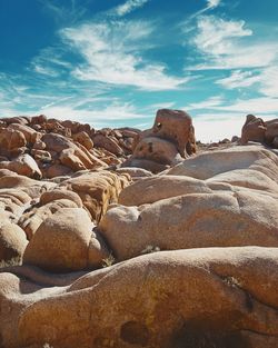 Rocks on beach against sky