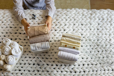 Midsection of woman sorting clothes