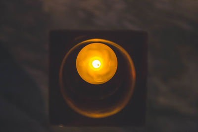 High angle view of illuminated candle