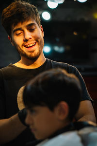 Portrait of young hairdresser and a boy