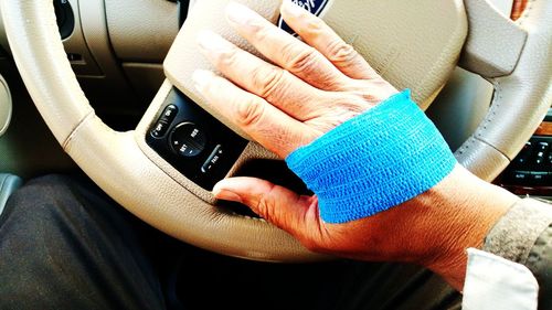 Close-up of woman hand in car