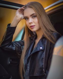 Portrait of beautiful young woman in car