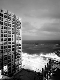 High angle view of buildings by sea against sky