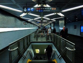 People on escalator at subway station