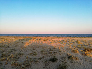 Scenic view of sea against clear sky during sunset