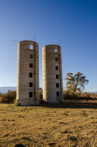 Ruins of antique concrete silos in california valley