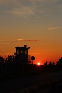 Silhouette building against sky during sunset