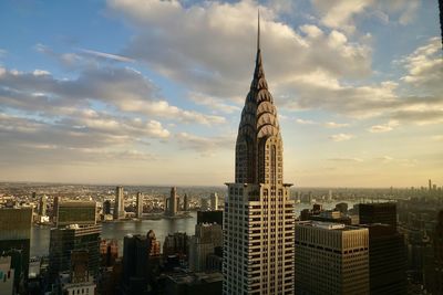 Buildings in city against sky during sunset