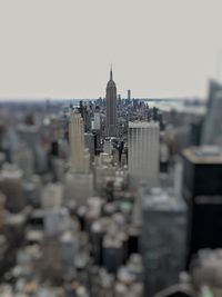 Buildings in city against clear sky