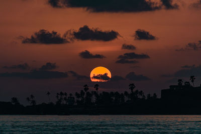 Scenic view of sea against romantic sky at sunset