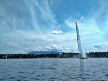 View of fountain in sea against cloudy sky