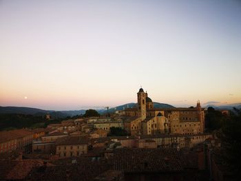 Buildings against sky at sunset