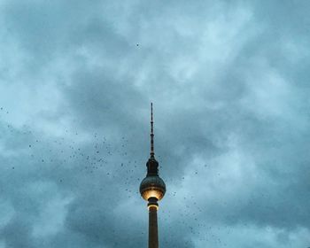 Low angle view of eiffel tower against cloudy sky