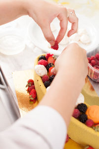 Midsection of woman holding fruits