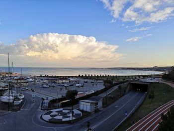 High angle view of city by sea against sky