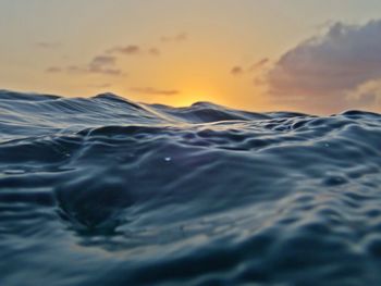 Close-up of sea against sky during sunset