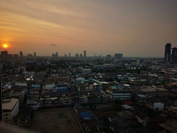 High angle view of buildings in city against sky during sunset