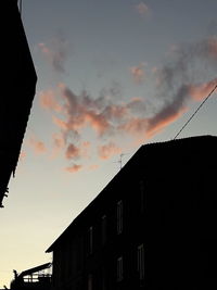 Low angle view of silhouette buildings against sky