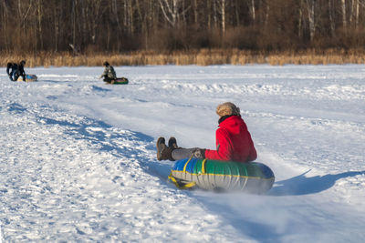 Man kayaking on snow