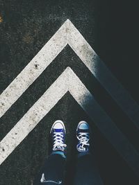 Low section of man standing on tiled floor