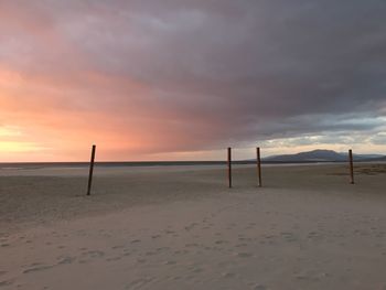 Scenic view of beach against sky during sunset