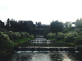 View of fountain in park against clear sky