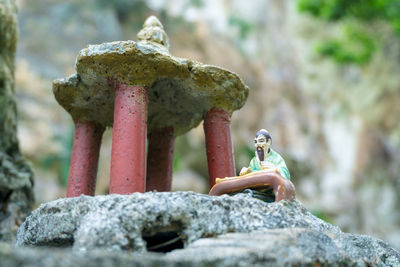 Close-up of statue against rock
