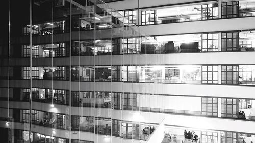 Reflection of building on glass window at night