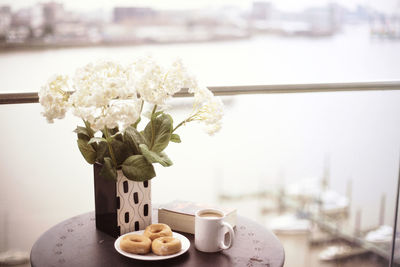 White flowers in vase on table