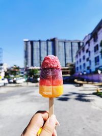 Cropped hand holding ice cream cone