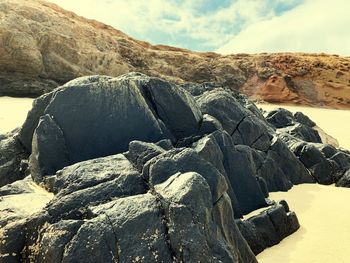 Rock formation on land against sky