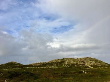 Scenic view of mountains against cloudy sky