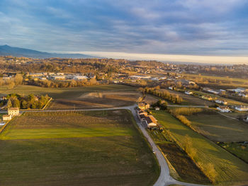 Aerial view of agricultural field against sky in city