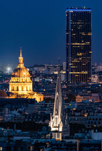 Illuminated cityscape against clear sky