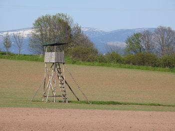 View of trees on field against sky