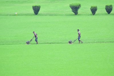 Men playing soccer on field