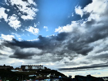 City buildings against cloudy sky