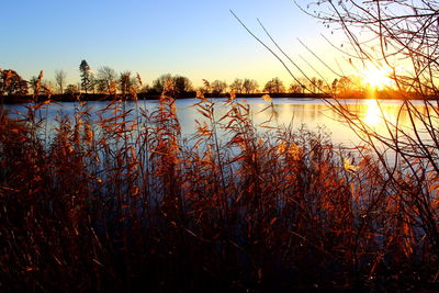 Scenic view of lake at sunset