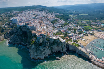 High angle view of buildings by sea