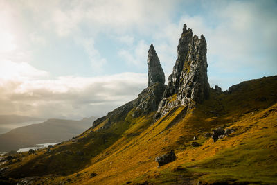 Old man of storr rock formations with golden light and dramatic sky on isle of skye scotland.