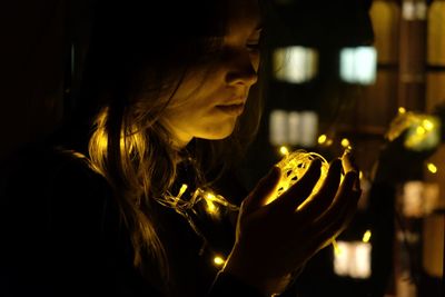 Portrait of a girl holding illuminated candles