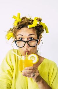 Portrait of mid adult man holding drink against white background