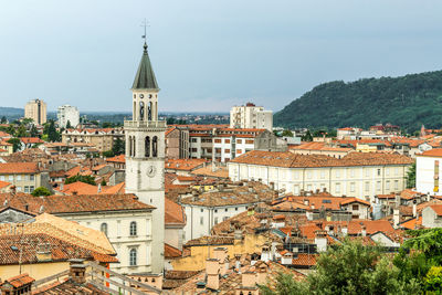 High angle view of buildings in town against sky