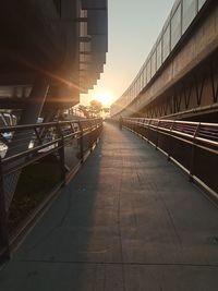 Bridge in city against sky during sunset