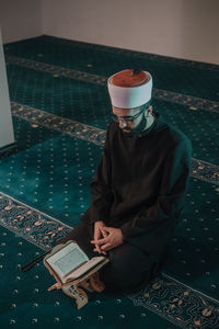 High angle view of man holding book