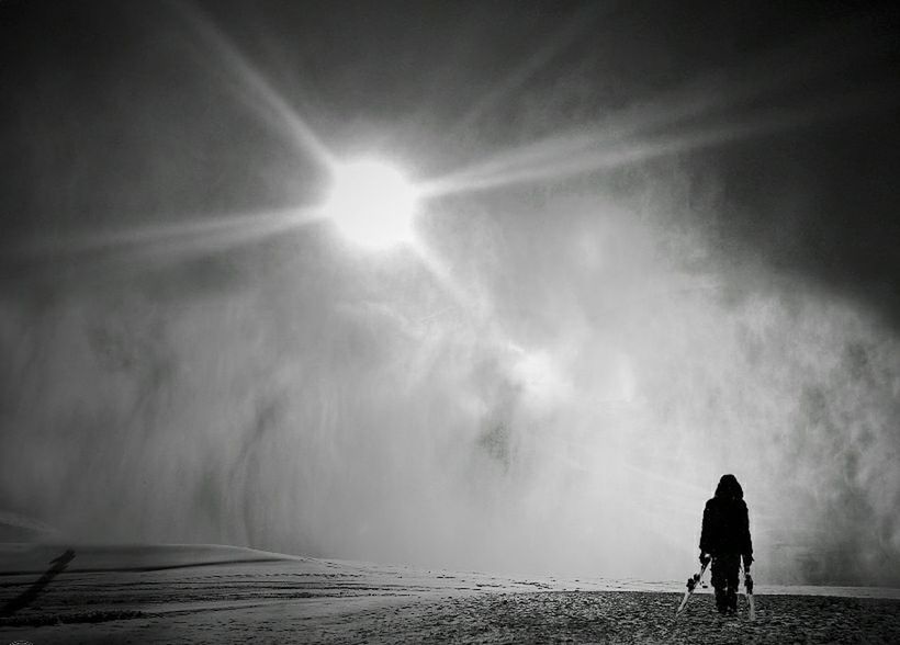 darkness, light, black and white, monochrome, one person, cloud, silhouette, sunlight, sky, nature, black, monochrome photography, rear view, full length, adult, sunbeam, environment, fog, back lit, outdoors, white, solitude, walking