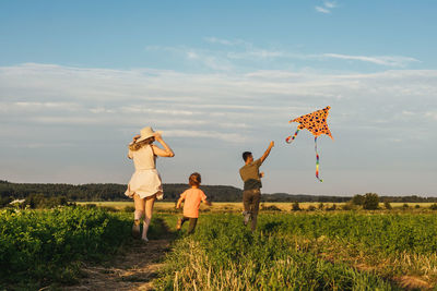 Parents with son walking on grassy land