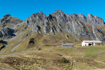 Scenic view of mountains against clear blue sky